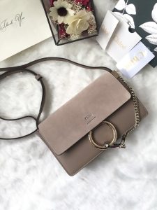 CHLOÉ 'Faye' Small Shoulder Bag. Authentic quality luxury bag crafted in genuine leather comes with authenticity card, dust bag and gift bag. Timeless style meets practicality. Combining functionality with elegance, the new Faye day bag embodies the Maison's nostalgic 70s aura. It boasts a practical magnet closure and spacious compartments, perfect for carrying all of your essentials. The double zips, accompanied by leather pullers, unveil suede gussets that create a delicate textural contrast and lend a feminine charm. Additionally, the bag features the line's distinctive ring loop and a hanging chain that exudes sophisticated hardware and a retro allure. - KRIS + KIKO CHLOÉ 'Faye' Small Shoulder Bag. Original Quality Bag including gift box, care book, dust bag, authenticity card. Functional yet elegant, the new Faye day bag taps into the Maison's 70s spirit while featuring a practical magnet closure and roomy compartments to carry all your belongings. Double zips with leather pullers open to reveal suede gussets for a subtle textural contrast adding a feminine touch. The line’s signature ring loop and hanging chain bring elegant hardware and retro appeal.