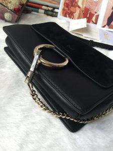 CHLOÉ 'Faye' Small Shoulder Bag. Authentic quality luxury bag crafted in genuine leather comes with authenticity card, dust bag and gift bag. Timeless style meets practicality. Combining functionality with elegance, the new Faye day bag embodies the Maison's nostalgic 70s aura. It boasts a practical magnet closure and spacious compartments, perfect for carrying all of your essentials. The double zips, accompanied by leather pullers, unveil suede gussets that create a delicate textural contrast and lend a feminine charm. Additionally, the bag features the line's distinctive ring loop and a hanging chain that exudes sophisticated hardware and a retro allure. - KRIS + KIKO CHLOÉ 'Faye' Small Shoulder Bag. Authentic quality luxury bag crafted in genuine leather comes with authenticity card, dust bag and gift bag. Timeless style meets practicality. Combining functionality with elegance, the new Faye day bag embodies the Maison's nostalgic 70s aura. It boasts a practical magnet closure and spacious compartments, perfect for carrying all of your essentials. The double zips, accompanied by leather pullers, unveil suede gussets that create a delicate textural contrast and lend a feminine charm. Additionally, the bag features the line's distinctive ring loop and a hanging chain that exudes sophisticated hardware and a retro allure.
