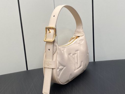LOUIS VUITTON Mini Moon. Authentic quality luxury bag crafted in genuine leather comes with authenticity card, dust bag and gift bag. The Perfect Compact Bag for Every Occasion. Introducing the Mini Moon, a fashionable and compact micro bag with a shoulder strap, crafted from soft and supple Monogram Empreinte leather. The embossed Monogram pattern adds a touch of sophistication, beautifully adorned with oversized and luxurious details, including the iconic LV Circle signature on the zipper pull. Perfectly suited for both daytime and evening outings, this versatile bag can be effortlessly carried on your shoulder, arm, or even by hand, making it a must-have for storing your essentials.
