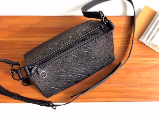 LOUIS VUITTON Triangle Messenger Bag. Original Quality Bag including gift box, care book, dust bag, authenticity card. Made from luxurious black Taurillon leather embossed with the Monogram motif, this Triangle Messenger bag is instantly recognizable by its unexpected triangular shape. The side and front leather straps allow both horizontal and vertical carry. Inspired by the design of the House’s Sac Tricot from 1934, Virgil Abloh has created a stylish small bag for men.