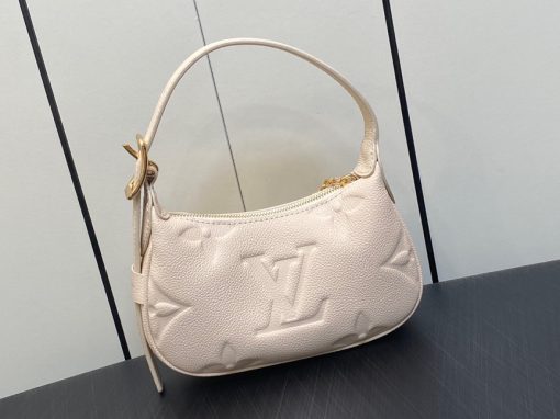 LOUIS VUITTON Mini Moon. Authentic quality luxury bag crafted in genuine leather comes with authenticity card, dust bag and gift bag. The Perfect Compact Bag for Every Occasion. Introducing the Mini Moon, a fashionable and compact micro bag with a shoulder strap, crafted from soft and supple Monogram Empreinte leather. The embossed Monogram pattern adds a touch of sophistication, beautifully adorned with oversized and luxurious details, including the iconic LV Circle signature on the zipper pull. Perfectly suited for both daytime and evening outings, this versatile bag can be effortlessly carried on your shoulder, arm, or even by hand, making it a must-have for storing your essentials.