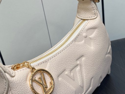 LOUIS VUITTON Mini Moon. Authentic quality luxury bag crafted in genuine leather comes with authenticity card, dust bag and gift bag. The Perfect Compact Bag for Every Occasion. Introducing the Mini Moon, a fashionable and compact micro bag with a shoulder strap, crafted from soft and supple Monogram Empreinte leather. The embossed Monogram pattern adds a touch of sophistication, beautifully adorned with oversized and luxurious details, including the iconic LV Circle signature on the zipper pull. Perfectly suited for both daytime and evening outings, this versatile bag can be effortlessly carried on your shoulder, arm, or even by hand, making it a must-have for storing your essentials.