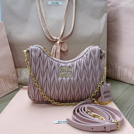 MIU MIU Matelassé Shoulder Bag. Authentic quality luxury bag crafted in genuine leather comes with authenticity card, dust bag and gift bag. Elevate your style with sophistication and craftsmanship. The exquisite matelassé technique exudes elegance and creates a visually captivating, multi-dimensional effect on this nappa leather shoulder bag. The beautifully crafted logo, reflecting the various metallic finishes of the hardware, effortlessly catches the eye, adding a touch of distinction to the immaculate artisanal work. Both functional and aesthetically pleasing, the detachable chain and leather shoulder straps perfectly meet your needs.