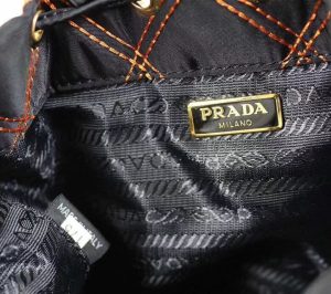 PRADA Quilted Bucket Bag. Authentic quality luxury bag crafted in genuine leather comes with authenticity card, dust bag and gift bag. Elevating Style with Quilted Luxury. Introducing the exquisite PRADA nylon bucket bag, featuring tessuto-impunturato quilted topstitching for a luxurious touch. Designed with a sleek leather top handle, this bag showcases a convenient drawstring top closure for easy access. It also includes a detachable shoulder strap, allowing for versatile carrying options. The front zip pocket, adorned with an elegant logo plate, adds a chic element to this stunning bag. - KRIS + KIKO PRADA Quilted Bucket Bag. Authentic quality luxury bag crafted in genuine leather comes with authenticity card, dust bag and gift bag. Elevating Style with Quilted Luxury. Introducing the exquisite PRADA nylon bucket bag, featuring tessuto-impunturato quilted topstitching for a luxurious touch. Designed with a sleek leather top handle, this bag showcases a convenient drawstring top closure for easy access. It also includes a detachable shoulder strap, allowing for versatile carrying options. The front zip pocket, adorned with an elegant logo plate, adds a chic element to this stunning bag.