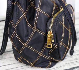 PRADA Quilted Bucket Bag. Authentic quality luxury bag crafted in genuine leather comes with authenticity card, dust bag and gift bag. Elevating Style with Quilted Luxury. Introducing the exquisite PRADA nylon bucket bag, featuring tessuto-impunturato quilted topstitching for a luxurious touch. Designed with a sleek leather top handle, this bag showcases a convenient drawstring top closure for easy access. It also includes a detachable shoulder strap, allowing for versatile carrying options. The front zip pocket, adorned with an elegant logo plate, adds a chic element to this stunning bag. - KRIS + KIKO PRADA Quilted Bucket Bag. Original Quality Bag including gift box, care book, dust bag, authenticity card. PRADA nylon bucket bag with tessuto-impunturato quilted topstitching. Leather top handle. Drawstring top. Detachable Shoulder Strap. Front Zip Pocket with logo plate.