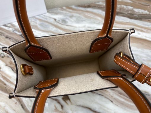 CELINE Cabas Triomphe Mini. Authentic quality luxury bag crafted in genuine leather comes with authenticity card, dust bag and gift bag. Elegance Meets Iconic Design The Triomphe bag initially had a lukewarm reception, but it is now steadily gaining attention and recognition. The origins of its story can be traced back to the stunning CELINE Triomphe bag, which pays homage to the iconic Arc de Triomphe. Embarking on a new chapter, CELINE has crafted an entire collection dedicated to the Triomphe line. This collection comprises a tote bag, bucket bag, camera bag, drawstring bag, and a Boston bag, all meticulously crafted from Triomphe canvas adorned with exquisite calfskin trimming.