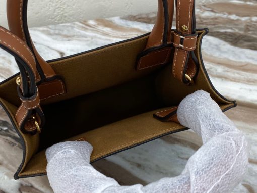 CELINE Cabas Triomphe Mini. Authentic quality luxury bag crafted in genuine leather comes with authenticity card, dust bag and gift bag. Elegance Meets Iconic Design The Triomphe bag initially had a lukewarm reception, but it is now steadily gaining attention and recognition. The origins of its story can be traced back to the stunning CELINE Triomphe bag, which pays homage to the iconic Arc de Triomphe. Embarking on a new chapter, CELINE has crafted an entire collection dedicated to the Triomphe line. This collection comprises a tote bag, bucket bag, camera bag, drawstring bag, and a Boston bag, all meticulously crafted from Triomphe canvas adorned with exquisite calfskin trimming.