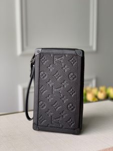 LOUIS VUITTON Soft Trunk Clutch. Authentic quality luxury bag crafted in genuine leather comes with authenticity card, dust bag and gift bag. Practical elegance for the modern gentleman. Introducing the sleek Soft Trunk Clutch designed specifically for men. Meticulously crafted from luxurious black Taurillon leather, this exquisite accessory features an embossed Monogram pattern. Boasting a refined rectilinear form and compact dimensions, it effortlessly accommodates your essential items such as a phone, earbuds, and credit cards. With a wide zipped opening for easy access and a removable wristband, it provides utmost practicality and convenience. - KRIS + KIKO LOUIS VUITTON Soft Trunk Clutch. Authentic quality luxury bag crafted in genuine leather comes with authenticity card, dust bag and gift bag. Practical elegance for the modern gentleman. Introducing the sleek Soft Trunk Clutch designed specifically for men. Meticulously crafted from luxurious black Taurillon leather, this exquisite accessory features an embossed Monogram pattern. Boasting a refined rectilinear form and compact dimensions, it effortlessly accommodates your essential items such as a phone, earbuds, and credit cards. With a wide zipped opening for easy access and a removable wristband, it provides utmost practicality and convenience.