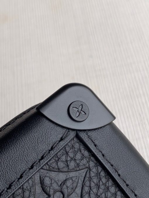 LOUIS VUITTON Soft Trunk Clutch. Authentic quality luxury bag crafted in genuine leather comes with authenticity card, dust bag and gift bag. Practical elegance for the modern gentleman. Introducing the sleek Soft Trunk Clutch designed specifically for men. Meticulously crafted from luxurious black Taurillon leather, this exquisite accessory features an embossed Monogram pattern. Boasting a refined rectilinear form and compact dimensions, it effortlessly accommodates your essential items such as a phone, earbuds, and credit cards. With a wide zipped opening for easy access and a removable wristband, it provides utmost practicality and convenience.