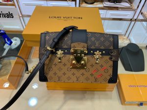 LOUIS VUITTON Trunk Clutch. Authentic quality luxury bag crafted in genuine leather comes with authenticity card, dust bag and gift bag. Style meets functionality in perfect harmony. The Trunk Clutch, designed with a soft-sided silhouette, pays homage to the rich heritage of the House, showcasing exquisite details reminiscent of the iconic LOUIS VUITTON luggage. Crafted in supple yet firm Monogram and Monogram Reverse canvas, this clutch effortlessly combines style with practicality, offering ample space to carry your everyday essentials. Its lightweight nature adds to its charm, making it an essential accessory. Additionally, the clutch features a detachable chain-and-leather strap, providing you with multiple carrying options for this fashionable and distinctive masterpiece.