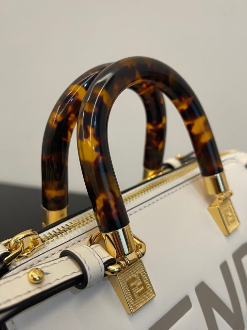 FENDI By The Way Mini. Authentic quality luxury bag crafted in genuine leather comes with authenticity card, dust bag and gift bag. Elevate your style with the iconic mini By The Way Boston bag – where luxury meets versatility. Introducing the iconic mini By The Way Boston bag, crafted from luxurious leather and embellished with the hot-stamped FENDI ROMA lettering. Its rigid handles are adorned with a exquisite tortoiseshell-like plexiglass finish. The bag's zip fastening opens to reveal a fabric-lined interior, complete with a convenient pocket and elegant gold-finish metalware. Versatile in nature, this bag can be carried by hand using the handles, or worn effortlessly on the shoulder or cross-body thanks to the detachable shoulder strap.