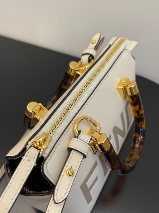 FENDI By The Way Mini. Authentic quality luxury bag crafted in genuine leather comes with authenticity card, dust bag and gift bag. Elevate your style with the iconic mini By The Way Boston bag – where luxury meets versatility. Introducing the iconic mini By The Way Boston bag, crafted from luxurious leather and embellished with the hot-stamped FENDI ROMA lettering. Its rigid handles are adorned with a exquisite tortoiseshell-like plexiglass finish. The bag's zip fastening opens to reveal a fabric-lined interior, complete with a convenient pocket and elegant gold-finish metalware. Versatile in nature, this bag can be carried by hand using the handles, or worn effortlessly on the shoulder or cross-body thanks to the detachable shoulder strap.