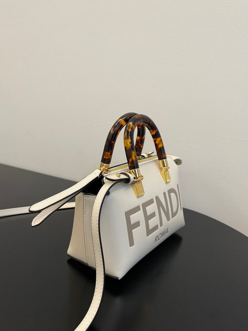 FENDI By The Way Mini. Authentic quality luxury bag crafted in genuine leather comes with authenticity card, dust bag and gift bag. Elevate your style with the iconic mini By The Way Boston bag – where luxury meets versatility. Introducing the iconic mini By The Way Boston bag, crafted from luxurious leather and embellished with the hot-stamped FENDI ROMA lettering. Its rigid handles are adorned with a exquisite tortoiseshell-like plexiglass finish. The bag's zip fastening opens to reveal a fabric-lined interior, complete with a convenient pocket and elegant gold-finish metalware. Versatile in nature, this bag can be carried by hand using the handles, or worn effortlessly on the shoulder or cross-body thanks to the detachable shoulder strap.
