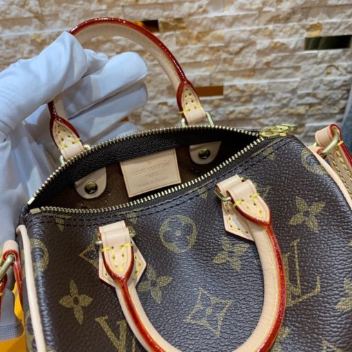 LOUIS VUITTON Nano Speedy Bag. Authentic quality luxury bag crafted in genuine leather comes with authenticity card, dust bag and gift bag. Effortless Chic for Everyday Essentials. This charming bag is a delightful miniature version of LOUIS VUITTON's iconic Speedy bag. Expertly crafted from Monogram canvas, with accents of natural leather trim, it boasts two handles and a convenient long strap for effortless shoulder or cross-body carry. Despite its compact size, this bag is surprisingly spacious, easily accommodating essentials such as a smartphone, cards, and keys. Its lightweight design adds to its allure, making it both practical and stylish for any occasion.