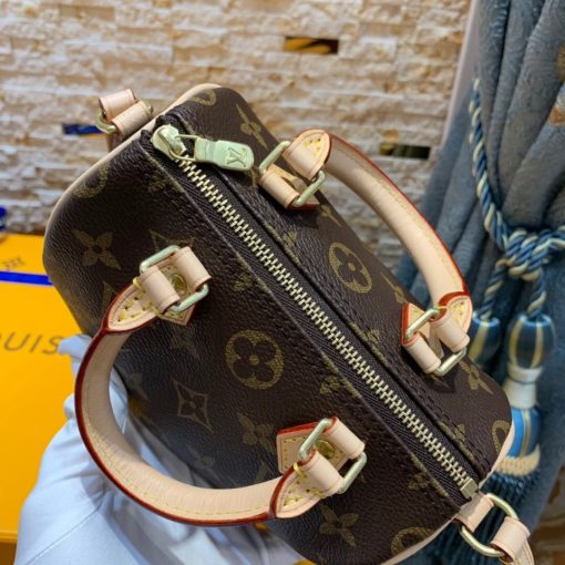 LOUIS VUITTON Nano Speedy Bag. Authentic quality luxury bag crafted in genuine leather comes with authenticity card, dust bag and gift bag. Effortless Chic for Everyday Essentials. This charming bag is a delightful miniature version of LOUIS VUITTON's iconic Speedy bag. Expertly crafted from Monogram canvas, with accents of natural leather trim, it boasts two handles and a convenient long strap for effortless shoulder or cross-body carry. Despite its compact size, this bag is surprisingly spacious, easily accommodating essentials such as a smartphone, cards, and keys. Its lightweight design adds to its allure, making it both practical and stylish for any occasion.