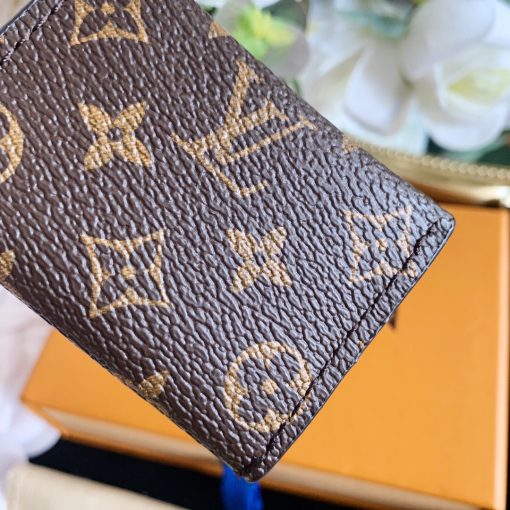 LOUIS VUITTON Kirigami Pouch Bag Charm & Key Holder. Authentic quality luxury accessory crafted in genuine leather comes with authenticity card, dust bag and gift bag. Exquisite Practicality, Perfected Elegance. The pouch bag charm and key holder effortlessly combine practicality and elegance. The design showcases the iconic Monogram canvas, adding a touch of versatility. With a functional pouch that opens through a convenient snap button, every detail is flawlessly crafted. Inside, a luxurious suede lining awaits, complemented by House emblems like the LV Circle charm and signature engraving, adding a distinctive touch.