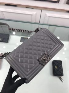 CHANEL 'Boy' Diamond Quilted Leather Flap Bag. Authentic quality luxury bag crafted in genuine leather comes with authenticity card, dust bag and gift bag. Embrace timeless elegance. The Chanel Boy Flap Bag Quilted, a creation by the visionary Karl Lagerfeld, pays tribute to Gabrielle Chanel's beloved Boy Capel. This exquisite bag, reminiscent of every woman's fantasy, is meticulously crafted from premium calfskin leather. It showcases Chanel's iconic diamond quilting, adorned with a bold chain link strap enhanced by a leather shoulder pad, and complemented by delicate metal-tone hardware accents. The bag's CC Boy logo closure gracefully reveals a fabric-lined interior, complete with a convenient slip pocket to house everyday essentials. Truly a cherished and opulent accessory coveted by many. - KRIS + KIKO CHANEL 'Boy' Diamond Quilted Leather Flap Bag. Original Quality Bag including gift box, care book, dust bag, authenticity card. Created by Karl Lagerfeld, the iconic design owes its name to Gabrielle Chanel's first love, Boy Capel. This Chanel Boy Flap Bag Quilted is every woman's dream. Crafted from calfskin leather, the bag features Chanel's signature diamond quilting, chunky chain link strap with leather shoulder pad, and metal-tone hardware accents. Its CC Boy logo closure opens to a fabric-lined interior with slip pocket perfect for daily essentials. A sought-after, luxurious accessory.
