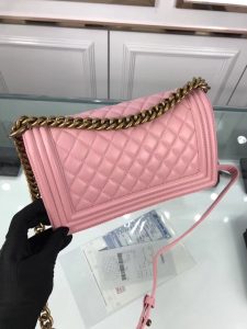 CHANEL 'Boy' Diamond Quilted Leather Flap Bag. Authentic quality luxury bag crafted in genuine leather comes with authenticity card, dust bag and gift bag. Embrace timeless elegance. The Chanel Boy Flap Bag Quilted, a creation by the visionary Karl Lagerfeld, pays tribute to Gabrielle Chanel's beloved Boy Capel. This exquisite bag, reminiscent of every woman's fantasy, is meticulously crafted from premium calfskin leather. It showcases Chanel's iconic diamond quilting, adorned with a bold chain link strap enhanced by a leather shoulder pad, and complemented by delicate metal-tone hardware accents. The bag's CC Boy logo closure gracefully reveals a fabric-lined interior, complete with a convenient slip pocket to house everyday essentials. Truly a cherished and opulent accessory coveted by many.