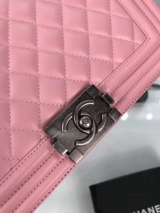CHANEL 'Boy' Diamond Quilted Leather Flap Bag. Authentic quality luxury bag crafted in genuine leather comes with authenticity card, dust bag and gift bag. Embrace timeless elegance. The Chanel Boy Flap Bag Quilted, a creation by the visionary Karl Lagerfeld, pays tribute to Gabrielle Chanel's beloved Boy Capel. This exquisite bag, reminiscent of every woman's fantasy, is meticulously crafted from premium calfskin leather. It showcases Chanel's iconic diamond quilting, adorned with a bold chain link strap enhanced by a leather shoulder pad, and complemented by delicate metal-tone hardware accents. The bag's CC Boy logo closure gracefully reveals a fabric-lined interior, complete with a convenient slip pocket to house everyday essentials. Truly a cherished and opulent accessory coveted by many.