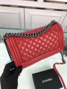 CHANEL 'Boy' Diamond Quilted Leather Flap Bag. Authentic quality luxury bag crafted in genuine leather comes with authenticity card, dust bag and gift bag. Embrace timeless elegance. The Chanel Boy Flap Bag Quilted, a creation by the visionary Karl Lagerfeld, pays tribute to Gabrielle Chanel's beloved Boy Capel. This exquisite bag, reminiscent of every woman's fantasy, is meticulously crafted from premium calfskin leather. It showcases Chanel's iconic diamond quilting, adorned with a bold chain link strap enhanced by a leather shoulder pad, and complemented by delicate metal-tone hardware accents. The bag's CC Boy logo closure gracefully reveals a fabric-lined interior, complete with a convenient slip pocket to house everyday essentials. Truly a cherished and opulent accessory coveted by many.