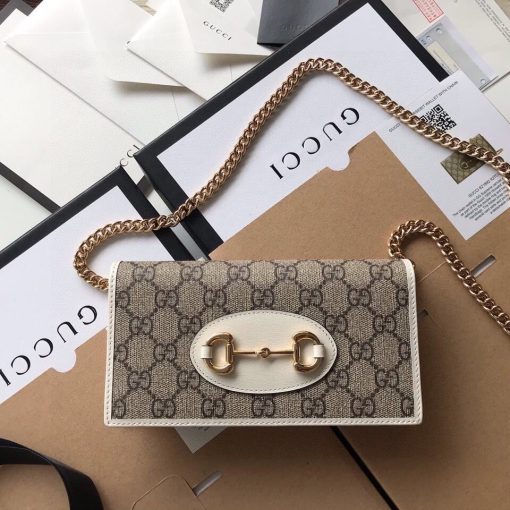 GUCCI 1955 GG Supreme Horsebit Wallet On Chain. Original Quality Wallet including gift box, care book, dust bag, authenticity card. This chain wallet in GG Supreme canvas and leather is introduced as part of the Gucci Horsebit 1955 accessories collection, defined by the double ring and bar design also found in Handbags. The folded snap-closure shape features several card slots and pockets, completed with a detachable chain strap.