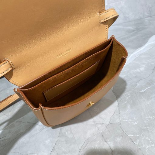 SAINT LAURENT Kaia YSL-Plaque Leather Cross-Body Bag. Authentic quality luxury bag crafted in genuine leather comes with authenticity card, dust bag and gift bag. Celebrating Artistry and Modern Sophistication. Introducing SAINT LAURENT'S Kaia bag, exquisitely showcasing the iconic YSL plaque designed by the renowned graphic artist A.M. Cassandre, celebrated as one of the giants of 20th-century poster art. Meticulously crafted from luxurious leather, this bag boasts a gracefully curved silhouette reminiscent of a saddle, elegantly adorned with pristine white topstitching. Enhancing its modern allure, this masterpiece comes with an adjustable shoulder strap for a touch of contemporary sophistication.