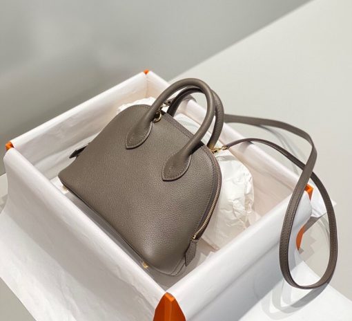 HERMÈS Bolide 1923 Mini. Authentic quality luxury bag crafted in genuine leather comes with authenticity card, dust bag and gift bag. Timeless Elegance, Unparalleled Convenience: The Bolide Bag – A Journey in Every Stitch. Created in 1923 with the discerning needs of elite drivers and seasoned long-distance travelers in mind, this globe-trotting bag effortlessly finds its place within any automobile trunk. Its iconic round-angled shape owes its origins to the zip fastener, a novel invention introduced to France by Émile Hermès in the late 1910s, and this innovative feature enables swift access to its contents. The Bolide bag is available in various sizes, including a travel-sized version, and a range of handbag options, offering both style and functionality to its fortunate owners.