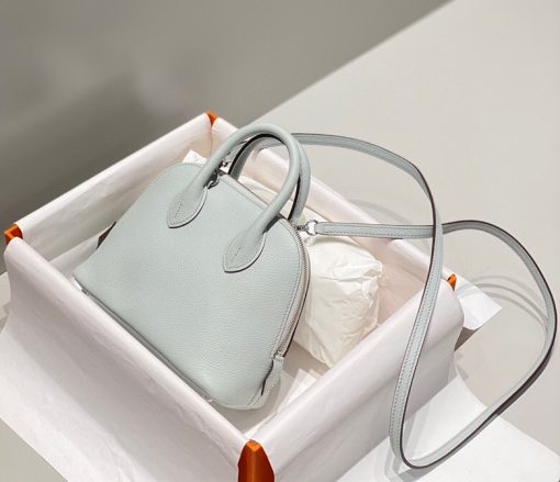HERMÈS Bolide 1923 Mini. Authentic quality luxury bag crafted in genuine leather comes with authenticity card, dust bag and gift bag. Timeless Elegance, Unparalleled Convenience: The Bolide Bag – A Journey in Every Stitch. Created in 1923 with the discerning needs of elite drivers and seasoned long-distance travelers in mind, this globe-trotting bag effortlessly finds its place within any automobile trunk. Its iconic round-angled shape owes its origins to the zip fastener, a novel invention introduced to France by Émile Hermès in the late 1910s, and this innovative feature enables swift access to its contents. The Bolide bag is available in various sizes, including a travel-sized version, and a range of handbag options, offering both style and functionality to its fortunate owners.