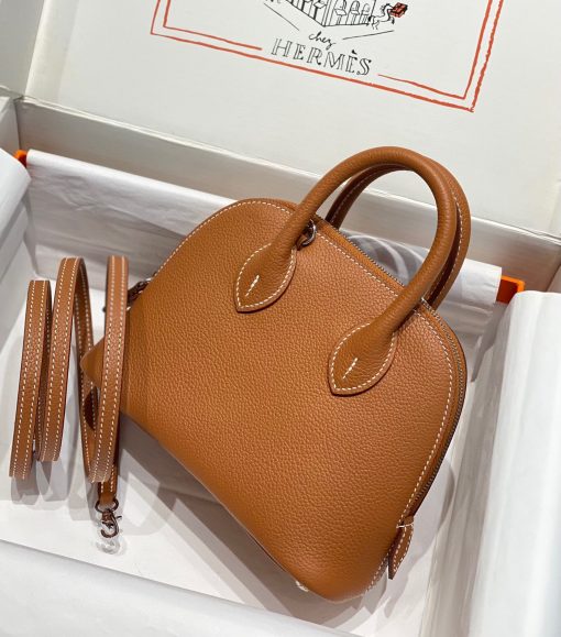 HERMÈS Bolide 1923 Mini. Authentic quality luxury bag crafted in genuine leather comes with authenticity card, dust bag and gift bag. Timeless Elegance, Unparalleled Convenience: The Bolide Bag – A Journey in Every Stitch. Created in 1923 with the discerning needs of elite drivers and seasoned long-distance travelers in mind, this globe-trotting bag effortlessly finds its place within any automobile trunk. Its iconic round-angled shape owes its origins to the zip fastener, a novel invention introduced to France by Émile Hermès in the late 1910s, and this innovative feature enables swift access to its contents. The Bolide bag is available in various sizes, including a travel-sized version, and a range of handbag options, offering both style and functionality to its fortunate owners.
