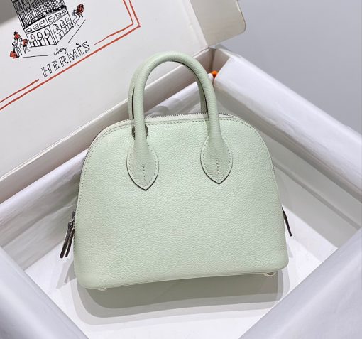 HERMÈS Bolide 1923 Mini. Authentic quality luxury bag crafted in genuine leather comes with authenticity card, dust bag and gift bag. Timeless Elegance, Unparalleled Convenience: The Bolide Bag – A Journey in Every Stitch. Created in 1923 with the discerning needs of elite drivers and seasoned long-distance travelers in mind, this globe-trotting bag effortlessly finds its place within any automobile trunk. Its iconic round-angled shape owes its origins to the zip fastener, a novel invention introduced to France by Émile Hermès in the late 1910s, and this innovative feature enables swift access to its contents. The Bolide bag is available in various sizes, including a travel-sized version, and a range of handbag options, offering both style and functionality to its fortunate owners.