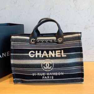 CHANEL Large Deauville Shopping Bag 2021. Authentic quality luxury bag crafted in genuine leather comes with authenticity card, dust bag and gift bag. Classic Elegance Meets Enduring Style. The CHANEL Deauville tote has evolved into an iconic CHANEL bag, gaining recognition as a popular choice. It frequently makes appearances in seasonal collections, showcasing surprising hues and materials. Interestingly, on the CHANEL website, it is referred to as the Shopping Bag; however, if you visit a CHANEL boutique and inquire about the Deauville, you will be guided to this exquisite tote bag. - KRIS + KIKO CHANEL Large Deauville Shopping Bag 2021. Authentic quality bag including gift box, booklet, dust bag, authenticity card. The CHANEL Deauville tote matured to a signature CHANEL bag. The bestseller Deauville often appears in seasonal launches in unexpected colors and materials. On the CHANEL website, Chanel calls it the Shopping Bag, but if you walk into a CHANEL boutique and ask for the Deauville, you will be directed to this tote bag.