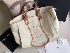 CHANEL Large Deauville Shopping Bag 2021. Authentic quality luxury bag crafted in genuine leather comes with authenticity card, dust bag and gift bag. Classic Elegance Meets Enduring Style. The CHANEL Deauville tote has evolved into an iconic CHANEL bag, gaining recognition as a popular choice. It frequently makes appearances in seasonal collections, showcasing surprising hues and materials. Interestingly, on the CHANEL website, it is referred to as the Shopping Bag; however, if you visit a CHANEL boutique and inquire about the Deauville, you will be guided to this exquisite tote bag. - KRIS + KIKO CHANEL Large Deauville Shopping Bag 2021. Authentic quality bag including gift box, booklet, dust bag, authenticity card. The CHANEL Deauville tote matured to a signature CHANEL bag. The bestseller Deauville often appears in seasonal launches in unexpected colors and materials. On the CHANEL website, Chanel calls it the Shopping Bag, but if you walk into a CHANEL boutique and ask for the Deauville, you will be directed to this tote bag.