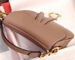DIOR Saddle Shoulder Bag. Authentic quality luxury bag crafted in genuine leather comes with authenticity card, dust bag and gift bag. Equestrian-inspired luxury, crafted for timeless style. It was originally introduced by designer John Galliano in the late 1990s and has since become an iconic accessory in the fashion world. The bag features a unique curved shape resembling a horse saddle, hence the name. It is crafted from high-quality materials such as smooth calfskin or the classic Dior Oblique canvas, and often adorned with the brand's signature logo hardware. The bag can be worn crossbody or over the shoulder, offering versatility and functionality. With its timeless design and elegant aesthetic, the DIOR Saddle Shoulder Bag has gained a cult following and remains a coveted item among fashion enthusiasts. - KRIS + KIKO DIOR Saddle Shoulder Bag. Authentic quality luxury bag crafted in genuine leather comes with authenticity card, dust bag and gift bag. Equestrian-inspired luxury, crafted for timeless style. It was originally introduced by designer John Galliano in the late 1990s and has since become an iconic accessory in the fashion world. The bag features a unique curved shape resembling a horse saddle, hence the name. It is crafted from high-quality materials such as smooth calfskin or the classic Dior Oblique canvas, and often adorned with the brand's signature logo hardware. The bag can be worn crossbody or over the shoulder, offering versatility and functionality. With its timeless design and elegant aesthetic, the DIOR Saddle Shoulder Bag has gained a cult following and remains a coveted item among fashion enthusiasts.