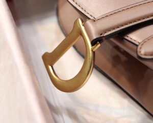 DIOR Saddle Shoulder Bag. Authentic quality luxury bag crafted in genuine leather comes with authenticity card, dust bag and gift bag. Equestrian-inspired luxury, crafted for timeless style. It was originally introduced by designer John Galliano in the late 1990s and has since become an iconic accessory in the fashion world. The bag features a unique curved shape resembling a horse saddle, hence the name. It is crafted from high-quality materials such as smooth calfskin or the classic Dior Oblique canvas, and often adorned with the brand's signature logo hardware. The bag can be worn crossbody or over the shoulder, offering versatility and functionality. With its timeless design and elegant aesthetic, the DIOR Saddle Shoulder Bag has gained a cult following and remains a coveted item among fashion enthusiasts. - KRIS + KIKO DIOR Saddle Shoulder Bag. Original Quality Bag. Authentic Style. Genuine Calf Leather. Metal Hardware. Authentic Packaging. Original Quality Dust Bag.