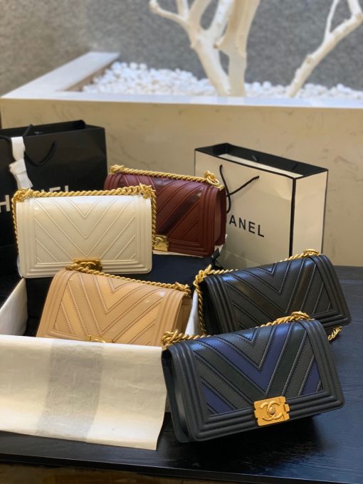CHANEL Medium Chevron Mix Leather Boy Bag. Authentic quality luxury bag crafted in genuine leather comes with authenticity card, dust bag and gift bag. Elevate your style with iconic Boy Bag - the epitome of luxury and sophistication! Chanel is proudly presenting a fresh and captivating design for their beloved Boy Bag. As part of their remarkable Spring/Summer 2016 Collection, this exquisitely crafted handbag is skillfully adorned with a delightful combination of three luxurious leathers: Calfskin, Suede Calfskin, and Grained Calfskin. Its gilded metal handle-chain gives you the freedom to carry it gracefully in your hand or elegantly on your shoulder. This sensational shoulder bag not only embodies style but also offers the perfect size to carry your essential belongings, making it the ultimate choice for any occasion, day or night. Indulge in the timeless allure of Chanel with this exquisite piece!