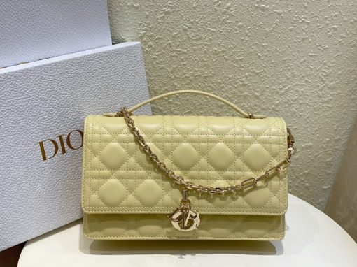 DIOR Miss Dior Top Handle Bag. Authentic quality luxury bag crafted in genuine leather comes with authenticity card, dust bag and gift bag. Your Day to Evening Essential. Elegance in Every Detail. Introducing the latest addition to the Cruise 2024 collection, the Miss Dior Top Handle bag embodies an exquisite blend of sophistication and functionality. Meticulously fashioned from luxurious black lambskin adorned with meticulous Cannage stitching, this bag showcases a gracefully adorned flap adorned by a captivating D.I.O.R. charm. Beneath this flap, you'll discover two spacious compartments and a secure zipped pouch, designed to effortlessly accommodate all your essentials, whether it's day or night. The signature Top Handle of this bag is both elegant and versatile, featuring a removable chain strap with a leather insert. This thoughtful design allows you to carry it comfortably in hand, wear it gracefully over your shoulder, or effortlessly sling it across your body for a stylish and adaptable look.