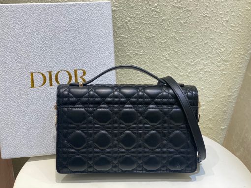 DIOR Miss Dior Top Handle Bag. Authentic quality luxury bag crafted in genuine leather comes with authenticity card, dust bag and gift bag. Your Day to Evening Essential. Elegance in Every Detail. Introducing the latest addition to the Cruise 2024 collection, the Miss Dior Top Handle bag embodies an exquisite blend of sophistication and functionality. Meticulously fashioned from luxurious black lambskin adorned with meticulous Cannage stitching, this bag showcases a gracefully adorned flap adorned by a captivating D.I.O.R. charm. Beneath this flap, you'll discover two spacious compartments and a secure zipped pouch, designed to effortlessly accommodate all your essentials, whether it's day or night. The signature Top Handle of this bag is both elegant and versatile, featuring a removable chain strap with a leather insert. This thoughtful design allows you to carry it comfortably in hand, wear it gracefully over your shoulder, or effortlessly sling it across your body for a stylish and adaptable look.
