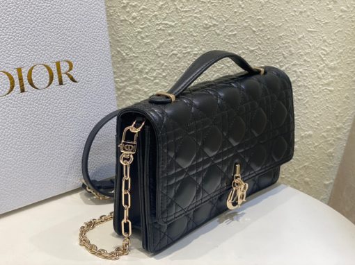 DIOR Miss Dior Top Handle Bag. Authentic quality luxury bag crafted in genuine leather comes with authenticity card, dust bag and gift bag. Your Day to Evening Essential. Elegance in Every Detail. Introducing the latest addition to the Cruise 2024 collection, the Miss Dior Top Handle bag embodies an exquisite blend of sophistication and functionality. Meticulously fashioned from luxurious black lambskin adorned with meticulous Cannage stitching, this bag showcases a gracefully adorned flap adorned by a captivating D.I.O.R. charm. Beneath this flap, you'll discover two spacious compartments and a secure zipped pouch, designed to effortlessly accommodate all your essentials, whether it's day or night. The signature Top Handle of this bag is both elegant and versatile, featuring a removable chain strap with a leather insert. This thoughtful design allows you to carry it comfortably in hand, wear it gracefully over your shoulder, or effortlessly sling it across your body for a stylish and adaptable look.