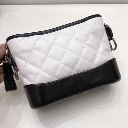 CHANEL Gabrielle Leather Hobo Bag. Authentic quality luxury bag crafted in genuine leather comes with authenticity card, dust bag and gift bag. Embodying the Future of Chanel with a Bold and Unforgettable Style. In an exclusive Chanel video, Karl Lagerfeld expressed his belief that the latest bag style, the Gabrielle, pays homage to Chanel's founder, Gabrielle Bonheur "Coco" Chanel. Lagerfeld explained that while she was known as Coco, her real name was Gabrielle, a fitting name for a handbag that embodies all the signature codes of Chanel. We wholeheartedly agree with Lagerfeld's sentiment. The Gabrielle is undeniably "perfectly Chanel", but with a fresh and bold twist. The inspiration behind the Chanel Gabrielle bag can be traced to virtual reality glasses and the binocular cases that men used to carry over their shoulders at the racecourse. While the bag incorporates iconic Chanel elements like quilting and a prominent CC logo, it has a distinct futuristic edge, as evident in its boxy shape. As per Chanel's literature, carrying the Gabrielle bag offers a truly unique experience. Its double straps can be effortlessly draped over the head, mimicking the ease of slipping on a sweater, and nonchalantly encircled around the neck and shoulder, resembling a long necklace. Karl Lagerfeld even emphasizes that the bag's strong aesthetic is reflective of the individuals who represent it, possessing equally strong looks and personalities.