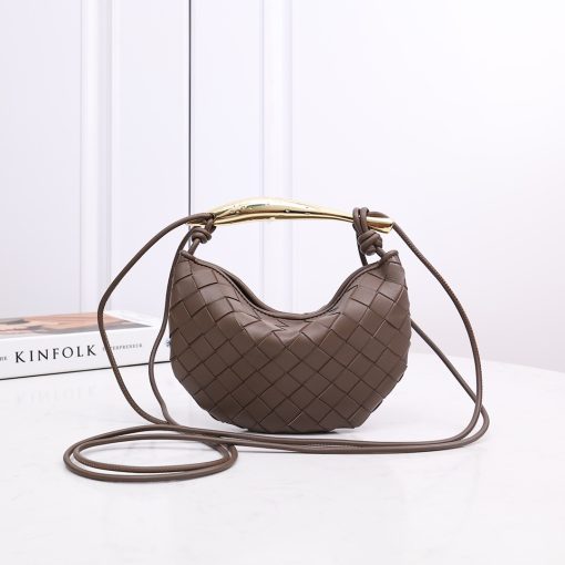 BOTTEGA VENETA Mini Sardine. Authentic quality luxury bag crafted in genuine leather comes with authenticity card, dust bag and gift bag. Crafted to Perfection, Inspired by Nature: Your Timeless Companion for All Occasions. BOTTEGA VENETA's masterful intrecciato weaving technique was originally crafted to ensure the enduring quality of leather goods. The Sardine Mini leather shoulder bag, meticulously fashioned from supple lamb leather, showcases a distinctive top handle reminiscent of a graceful fish. This versatile piece seamlessly transitions from day to night, making it the perfect, reliable companion to elegantly accommodate all your essentials.