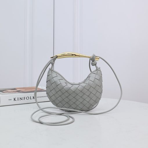 BOTTEGA VENETA Mini Sardine. Authentic quality luxury bag crafted in genuine leather comes with authenticity card, dust bag and gift bag. Crafted to Perfection, Inspired by Nature: Your Timeless Companion for All Occasions. BOTTEGA VENETA's masterful intrecciato weaving technique was originally crafted to ensure the enduring quality of leather goods. The Sardine Mini leather shoulder bag, meticulously fashioned from supple lamb leather, showcases a distinctive top handle reminiscent of a graceful fish. This versatile piece seamlessly transitions from day to night, making it the perfect, reliable companion to elegantly accommodate all your essentials.