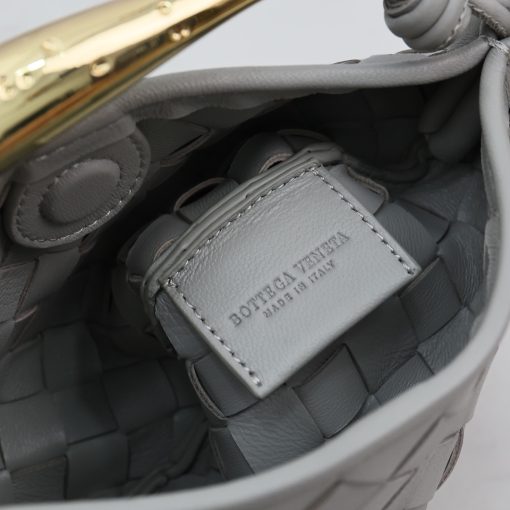 BOTTEGA VENETA Mini Sardine. Authentic quality luxury bag crafted in genuine leather comes with authenticity card, dust bag and gift bag. Crafted to Perfection, Inspired by Nature: Your Timeless Companion for All Occasions. BOTTEGA VENETA's masterful intrecciato weaving technique was originally crafted to ensure the enduring quality of leather goods. The Sardine Mini leather shoulder bag, meticulously fashioned from supple lamb leather, showcases a distinctive top handle reminiscent of a graceful fish. This versatile piece seamlessly transitions from day to night, making it the perfect, reliable companion to elegantly accommodate all your essentials.