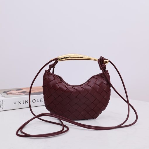 BOTTEGA VENETA Mini Sardine. Authentic quality luxury bag crafted in genuine leather comes with authenticity card, dust bag and gift bag. Crafted to Perfection, Inspired by Nature: Your Timeless Companion for All Occasions. BOTTEGA VENETA's masterful intrecciato weaving technique was originally crafted to ensure the enduring quality of leather goods. The Sardine Mini leather shoulder bag, meticulously fashioned from supple lamb leather, showcases a distinctive top handle reminiscent of a graceful fish. This versatile piece seamlessly transitions from day to night, making it the perfect, reliable companion to elegantly accommodate all your essentials.