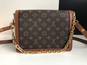 LOUIS VUITTON Dauphine MM Shoulder Bag. Authentic quality luxury bag crafted in genuine leather comes with authenticity card, dust bag and gift bag. A Modern Must-Have. Nicolas Ghesquière presents a captivating addition to the Spring-Summer 2019 collection: the Dauphine Mini handbag. This charming and sleek design is exquisitely crafted using Monogram and Monogram Reverse canvas, elegantly accentuated with smooth tan calfskin trim. The striking LV lock and leather smart strap bring a contemporary touch to this iconic piece, perfectly sized for seamless transitions from day to night. - KRIS + KIKO LOUIS VUITTON Dauphine MM Shoulder Bag. Authentic quality luxury bag crafted in genuine leather comes with authenticity card, dust bag and gift bag. A Modern Must-Have. Nicolas Ghesquière presents a captivating addition to the Spring-Summer 2019 collection: the Dauphine Mini handbag. This charming and sleek design is exquisitely crafted using Monogram and Monogram Reverse canvas, elegantly accentuated with smooth tan calfskin trim. The striking LV lock and leather smart strap bring a contemporary touch to this iconic piece, perfectly sized for seamless transitions from day to night.