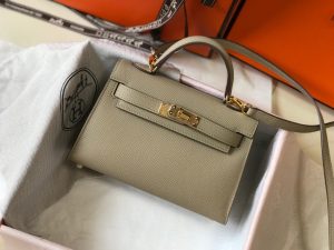 HERMÈS 'Mini Kelly’ Sellier II Leather Shoulder Bag. Authentic quality luxury bag crafted in genuine leather comes with authenticity card, dust bag and gift bag. Style meets functionality. Hermès has ingeniously crafted the ideal Kelly bag that strikes the perfect balance. Slightly larger than the sought-after baby Kelly Micro and smaller than the timeless classic Kelly, this exquisite creation effortlessly accommodates our modern gadgets, including our beloved smartphones, without compromising its charming and petite character. While it may not serve the exact purpose that earned it its name (as Grace Kelly famously concealed her baby bump with the bag in the 1950s), we wholeheartedly cherish it nonetheless. Today, embracing and showcasing our modern baby bellies is the new trend, after all. - KRIS + KIKO HERMÈS 'Mini Kelly’ Sellier II Leather Shoulder Bag. Original Quality Bag. Metal toned Hardware. HERMÈS Sales Box and Dust Bag. Booklet, Authenticity Card, Payment Slip. Lock, keys, clochette. Hermès has created the perfect Kelly. Just a little bigger than the covetable baby Kelly Micro and smaller than the beautifully classic Kelly, it's been made to fit all our modern contraptions—smart phones included—while maintaining its petite insouciance. It may not be able to be utilized the same way it got its name (Grace Kelly famously held the bag over her body in photos to conceal her baby bump in the 1950s), but we love it just the same. Modern baby bellies are for flaunting, anyway.