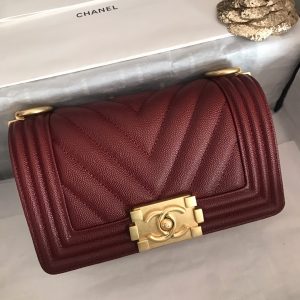 CHANEL Chevron Quilted Leather Flap Bag. Authentic quality luxury bag crafted in genuine leather comes with authenticity card, dust bag and gift bag. A love story in every stitch. The Chanel Boy Flap Bag Quilted is an exquisite creation by the renowned Karl Lagerfeld, paying homage to Gabrielle Chanel's beloved Boy Capel. This iconic design truly represents every woman's ultimate aspiration. Meticulously crafted from high-quality calfskin leather, this bag showcases Chanel's distinctive chevron quilting, complemented by a striking chunky chain link strap adorned with a leather shoulder pad and elegant metal-tone hardware accents. Opening with a captivating CC Boy logo closure, its fabric-lined interior includes a convenient slip pocket, ideal for organizing daily essentials. With its undeniable allure, this sought-after accessory is a luxurious must-have. - KRIS + KIKO CHANEL Chevron Quilted Leather Flap Bag. Original high quality bag. Authentic design. Original quality printed dust bag and sales box. Created by Karl Lagerfeld, the iconic design owes its name to Gabrielle Chanel's first love, Boy Capel. This Chanel Boy Flap Bag Quilted is every woman's dream. Crafted from calfskin leather, the bag features Chanel's signature chevron quilting, chunky chain link strap with leather shoulder pad, and metal-tone hardware accents. Its CC Boy logo closure opens to a fabric-lined interior with slip pocket perfect for daily essentials. A sought-after, luxurious accessory.