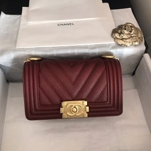 CHANEL Chevron Quilted Leather Flap Bag. Original high quality bag. Authentic design. Original quality printed dust bag and sales box. Created by Karl Lagerfeld, the iconic design owes its name to Gabrielle Chanel's first love, Boy Capel. This Chanel Boy Flap Bag Quilted is every woman's dream. Crafted from calfskin leather, the bag features Chanel's signature chevron quilting, chunky chain link strap with leather shoulder pad, and metal-tone hardware accents. Its CC Boy logo closure opens to a fabric-lined interior with slip pocket perfect for daily essentials. A sought-after, luxurious accessory.