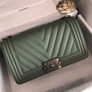 CHANEL Chevron Quilted Leather Flap Bag. Authentic quality luxury bag crafted in genuine leather comes with authenticity card, dust bag and gift bag. A love story in every stitch. The Chanel Boy Flap Bag Quilted is an exquisite creation by the renowned Karl Lagerfeld, paying homage to Gabrielle Chanel's beloved Boy Capel. This iconic design truly represents every woman's ultimate aspiration. Meticulously crafted from high-quality calfskin leather, this bag showcases Chanel's distinctive chevron quilting, complemented by a striking chunky chain link strap adorned with a leather shoulder pad and elegant metal-tone hardware accents. Opening with a captivating CC Boy logo closure, its fabric-lined interior includes a convenient slip pocket, ideal for organizing daily essentials. With its undeniable allure, this sought-after accessory is a luxurious must-have. - KRIS + KIKO CHANEL Chevron Quilted Leather Flap Bag. Original high quality bag. Authentic design. Original quality printed dust bag and sales box. Created by Karl Lagerfeld, the iconic design owes its name to Gabrielle Chanel's first love, Boy Capel. This Chanel Boy Flap Bag Quilted is every woman's dream. Crafted from calfskin leather, the bag features Chanel's signature chevron quilting, chunky chain link strap with leather shoulder pad, and metal-tone hardware accents. Its CC Boy logo closure opens to a fabric-lined interior with slip pocket perfect for daily essentials. A sought-after, luxurious accessory.