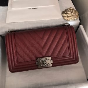 CHANEL Chevron Quilted Leather Flap Bag. Authentic quality luxury bag crafted in genuine leather comes with authenticity card, dust bag and gift bag. A love story in every stitch. The Chanel Boy Flap Bag Quilted is an exquisite creation by the renowned Karl Lagerfeld, paying homage to Gabrielle Chanel's beloved Boy Capel. This iconic design truly represents every woman's ultimate aspiration. Meticulously crafted from high-quality calfskin leather, this bag showcases Chanel's distinctive chevron quilting, complemented by a striking chunky chain link strap adorned with a leather shoulder pad and elegant metal-tone hardware accents. Opening with a captivating CC Boy logo closure, its fabric-lined interior includes a convenient slip pocket, ideal for organizing daily essentials. With its undeniable allure, this sought-after accessory is a luxurious must-have. - KRIS + KIKO CHANEL Chevron Quilted Leather Flap Bag. Authentic quality luxury bag crafted in genuine leather comes with authenticity card, dust bag and gift bag. A love story in every stitch. The Chanel Boy Flap Bag Quilted is an exquisite creation by the renowned Karl Lagerfeld, paying homage to Gabrielle Chanel's beloved Boy Capel. This iconic design truly represents every woman's ultimate aspiration. Meticulously crafted from high-quality calfskin leather, this bag showcases Chanel's distinctive chevron quilting, complemented by a striking chunky chain link strap adorned with a leather shoulder pad and elegant metal-tone hardware accents. Opening with a captivating CC Boy logo closure, its fabric-lined interior includes a convenient slip pocket, ideal for organizing daily essentials. With its undeniable allure, this sought-after accessory is a luxurious must-have.
