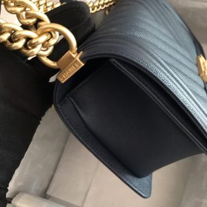 CHANEL Chevron Quilted Leather Flap Bag. Original high quality bag. Authentic design. Original quality printed dust bag and sales box. Created by Karl Lagerfeld, the iconic design owes its name to Gabrielle Chanel's first love, Boy Capel. This Chanel Boy Flap Bag Quilted is every woman's dream. Crafted from calfskin leather, the bag features Chanel's signature chevron quilting, chunky chain link strap with leather shoulder pad, and metal-tone hardware accents. Its CC Boy logo closure opens to a fabric-lined interior with slip pocket perfect for daily essentials. A sought-after, luxurious accessory.